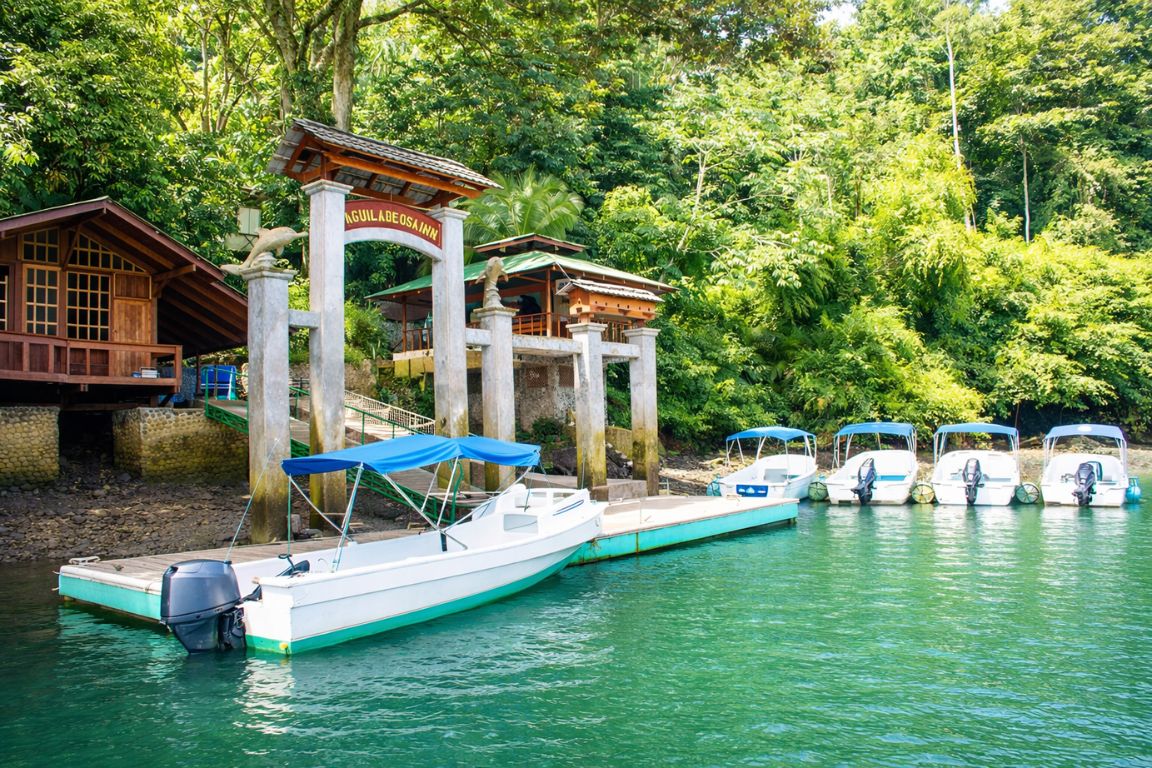 Aguila de Osa Inn entrance and marina with small boats in Costa Rica jungle setting, photographed during our Corcovado National Park Tours experience